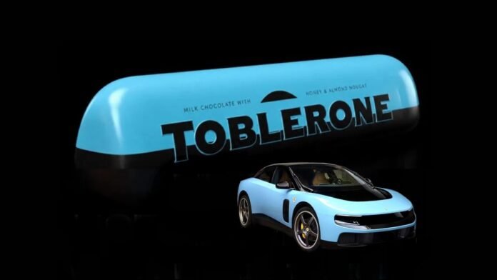 Toblerone τρολάρει Ferrari: χιουμοριστική εικόνα σοκολάτας χωρίς τρίγωνα, αναφορά στο ηλεκτρικό Luce και μπλε απόχρωση